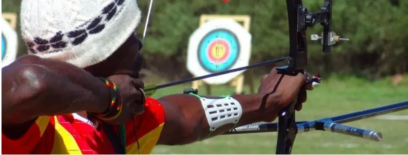 Portrait of a veteran Nigerian archer in front of a target