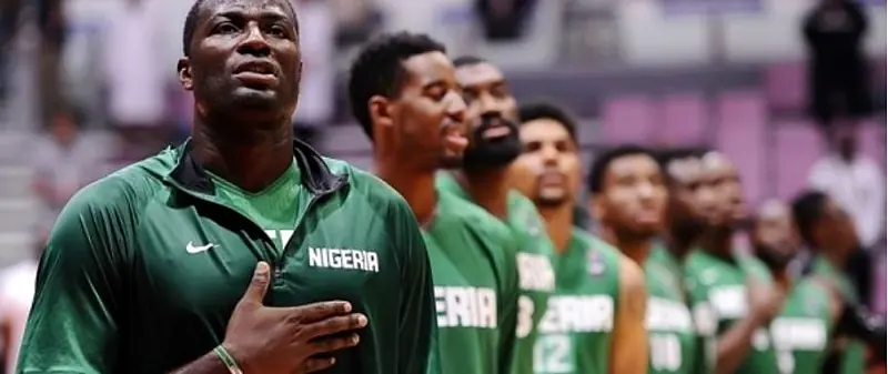 D'Tigers players stand for the national anthem before an international game