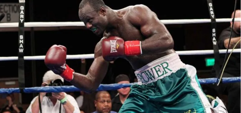 A Nigerian boxer throwing a right hand in a professional bout