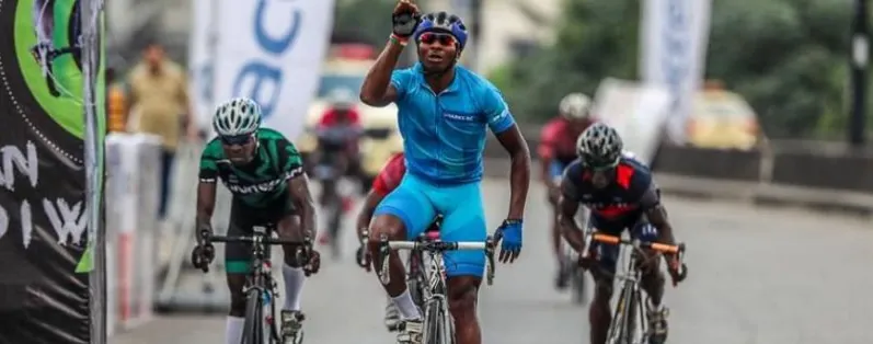 A Nigerian cyclist celebrating as he wins a road race