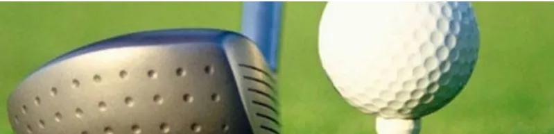 A golf ball on a tee beside a driver