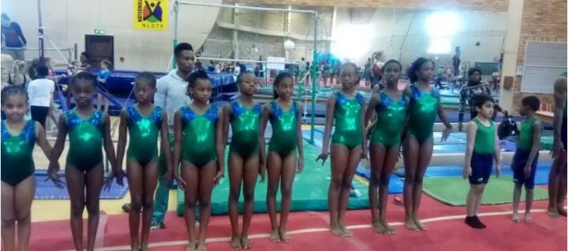 Young Nigerian gymnasts lined up in green leotards