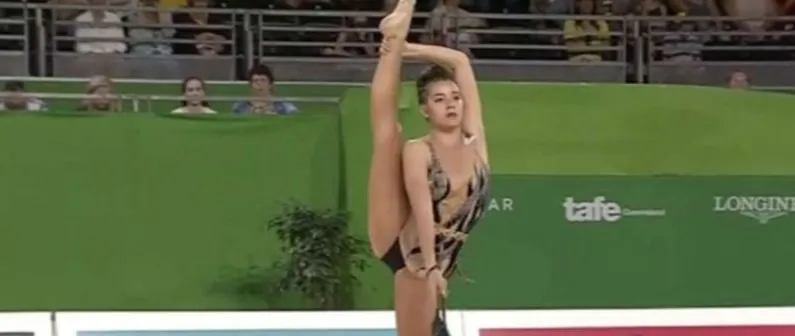 A rhythmic gymnast balancing in competition