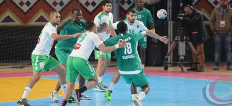 Nigerian players in green attacking the defence