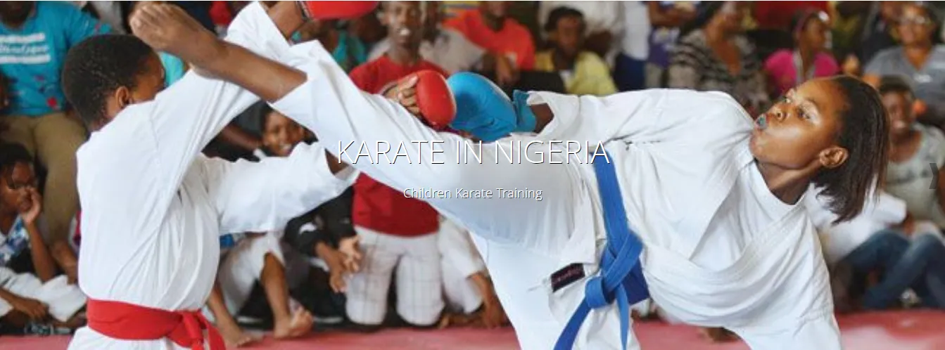 Nigerian karatekas sparring in front of a packed hall
