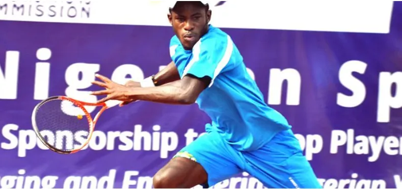 A Nigerian player in blue lunges for a forehand in front of a sponsor's banner at a national championship