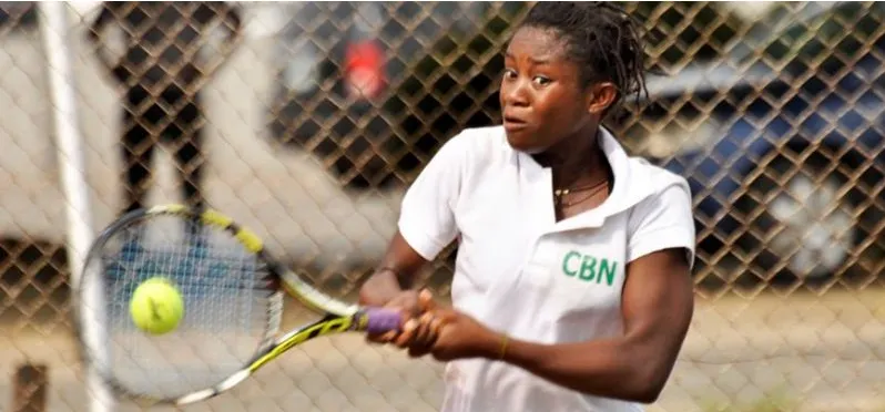 A Nigerian woman player hitting a two-handed backhand