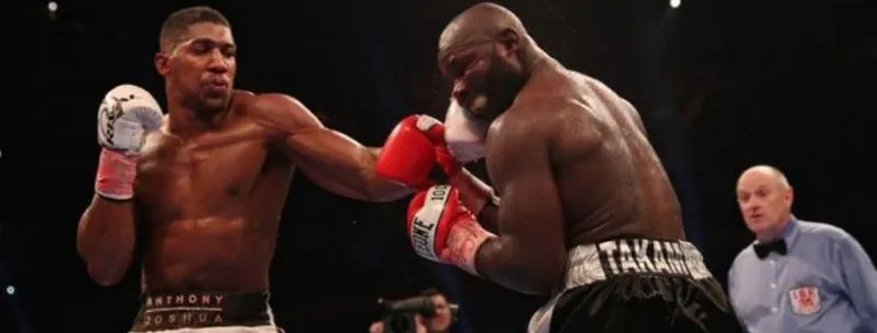 Anthony Joshua landing a right hand against Carlos Takam