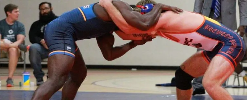 Two wrestlers locked in a clinch, the base of many MMA fighters