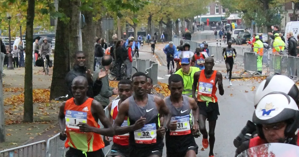 The leading group of runners in the Amsterdam Marathon passing spectators