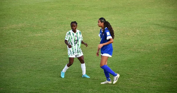 A Nigerian Under-17 player in green and white alongside a Samoa player
