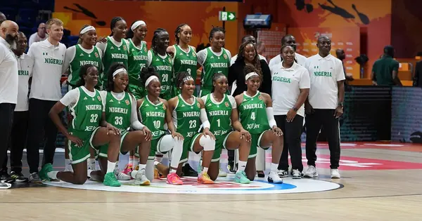Nigeria's women's basketball team posing for a team photo on court