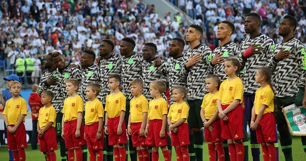 Nigeria's Super Eagles lined up with mascots before a match in Russia