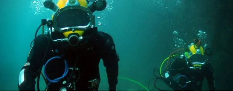 Divers descending into green Atlantic water
