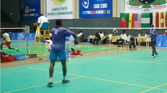 Badminton match on a green court at a Lagos State sports hall