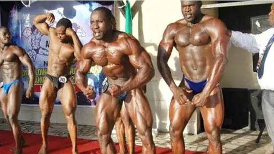 Bodybuilders posing on stage at a Nigerian championship