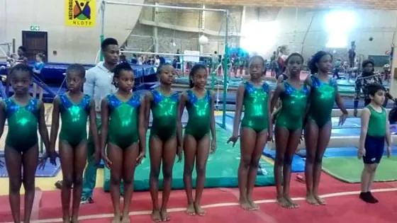 Young Nigerian gymnasts lined up in green leotards