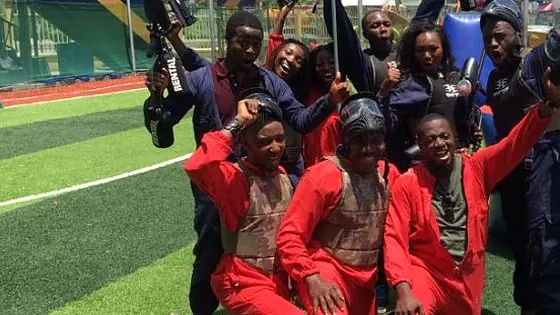 Nigerian paintball players posing in team kit with their markers