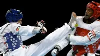 Taekwondo athletes exchanging kicks
