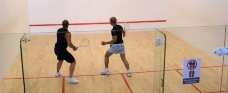 Two players in a rally on a glass court