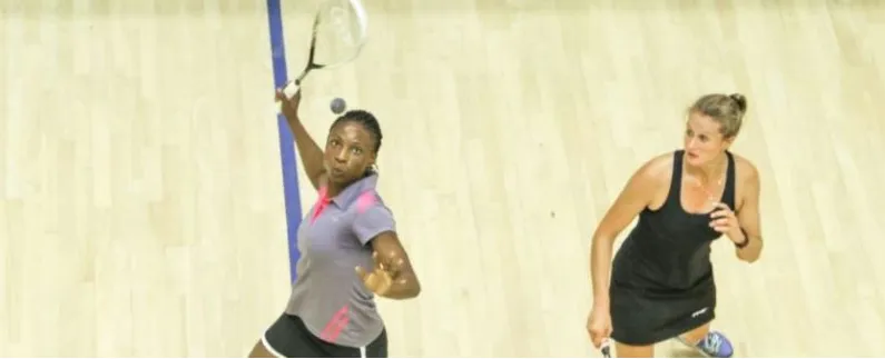 A Nigerian woman stretching for a shot in a tournament