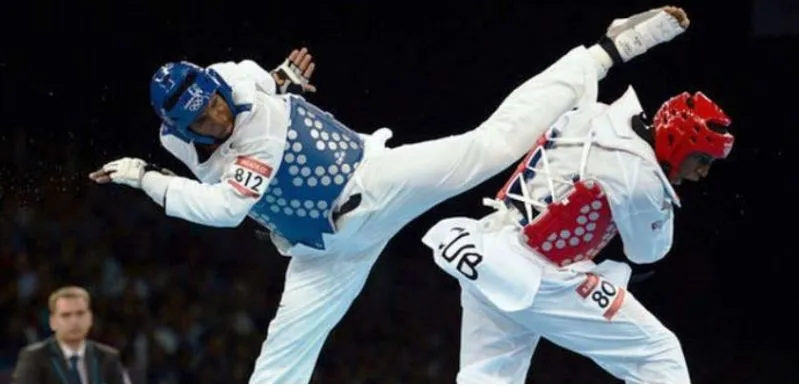 A fighter spinning into a kick